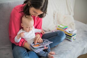 Mother and child read a book together
