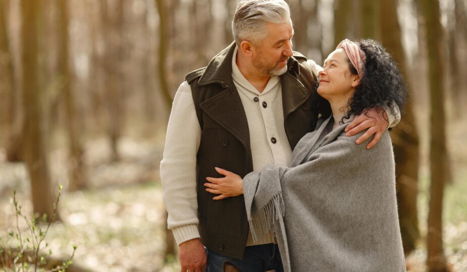 Middle-aged Christian couple smiling and walking outdoors, symbolising faith-based dating and companionship later in life