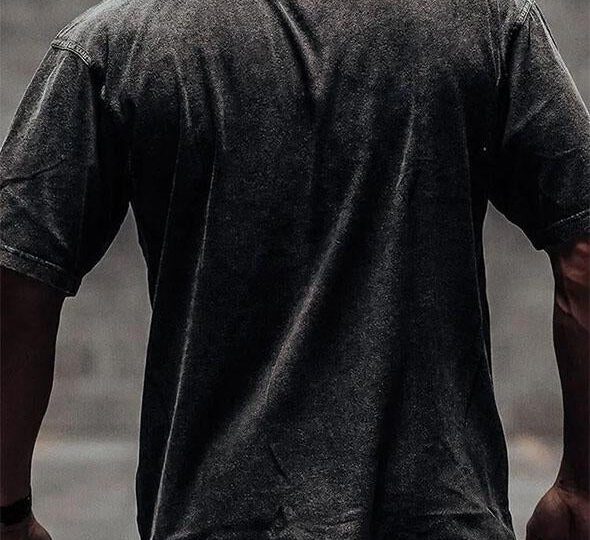 man wearing an autumn gym shirt, styled with leggings and trainers, showcasing a stylish workout outfit for the season